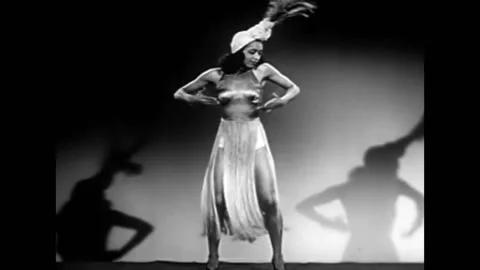 A scantily clad dancer performs a backstage dancing screen test in this 1940s Stock Footage 152668001