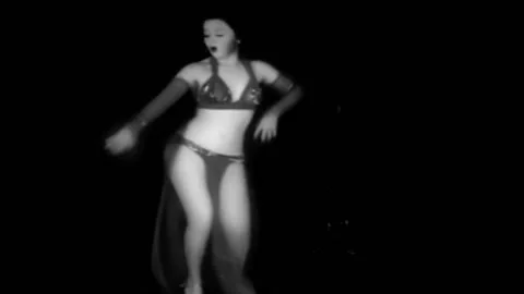 A scantily clad dancer performs a sexy exotic dance against a black backdrop in Stock Footage 152661525