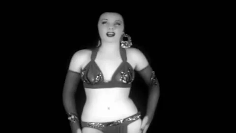 A scantily clad dancer performs a sexy exotic dance against a black backdrop in Stock Footage 152663664