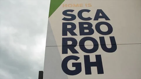 Scarborough text caption writing written on side of building in four lines rows Stock-Footage 247143582