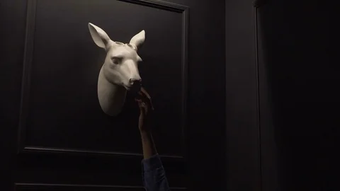 Scarecrow on a wall in a dark room. Hand girl touching and stroking a stuffed Stock Footage 71486773