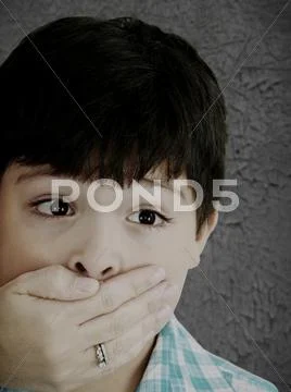 Scared 8 year old boy being abused or abducted by adult female. Stock Photos
