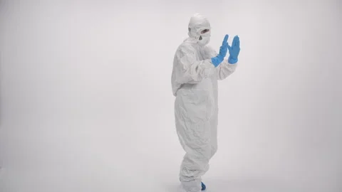 A scared and arrested scientist in PPE on a white background Stock Footage 297964978