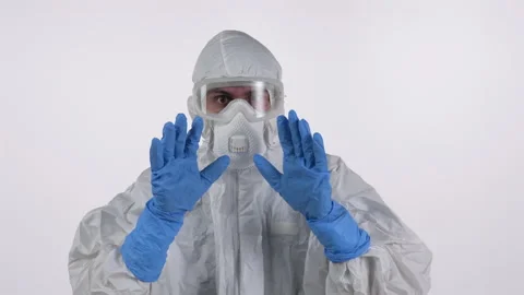 A scared and arrested scientist in PPE on a white background Stock Footage 297965329