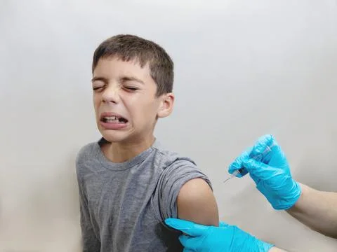 Scared and Crying Boy Getting Vaccine Foto stock