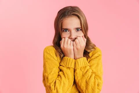 Scared beautiful blonde girl covering her face and looking at camera Stock Photos