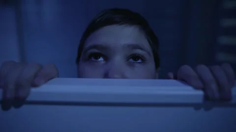 Scared boy hiding behind the bed Stock Footage 241016890