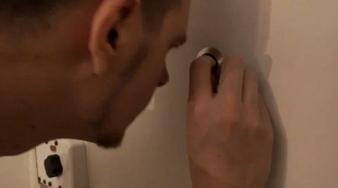 Scared boy looking through a peephole 스톡 동영상 37783622