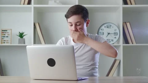 Scared boy shocked by terrible scene while reading horror news on computer Stock Footage 154594768