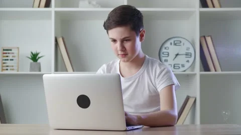 Scared boy shocked by terrible scene while watching horror video on computer Stock Footage 160902365