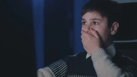 Scared boy shocked by terrible scene while watching horror video on computer Stock Footage 161055298