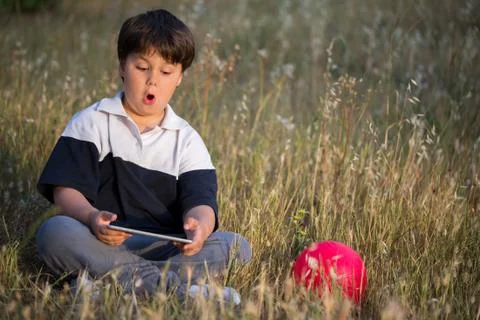 Scared boy surfing in the internet Stock Photos