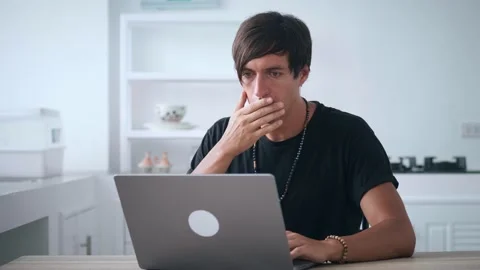 Scared business man getting bad results on computer at home office. Young male Stock Footage 174645116