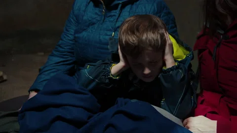 A scared child hiding in the basement with his family Stock Footage 171385653