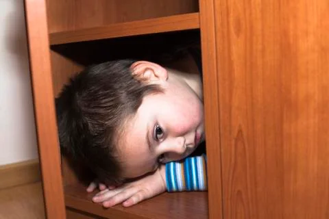 Scared child hiding Stock Photos