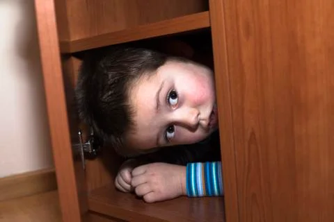 Scared child hiding Stock Photos