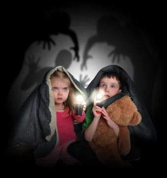 Scared children looking at night shadows Stockfoto's