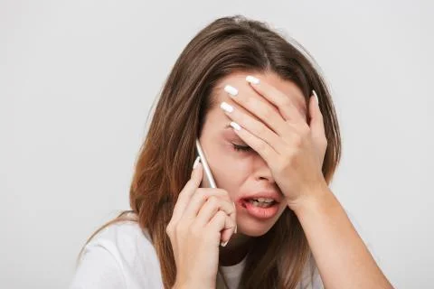 Scared crying woman talking on mobile phone Stock Photos