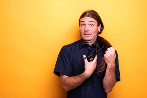 Scared funny face while cutting hair with scissors Stock Photos