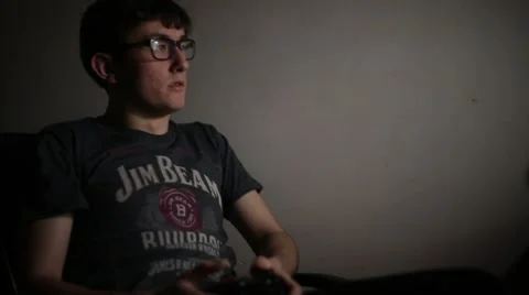 Scared Gamer Jumps While Playing Video Game Stock Footage 45843193
