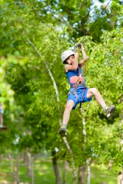 Scared kid on zip line summer day Stock Photos