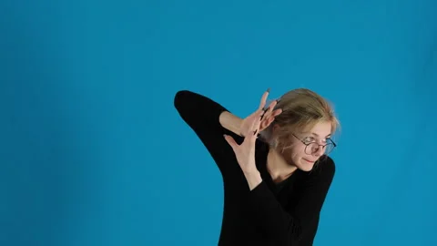 Scared lady hides behind hands peeking cautiously to side Stock Footage 306472947