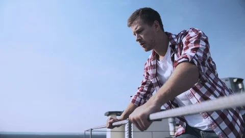 Scared male looking down standing rooftop, fear of heights, problem hopelessness Vidéo 117213544