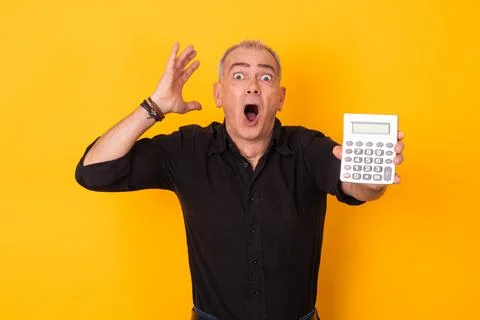 Scared man with calculator isolated on background Stock Photos