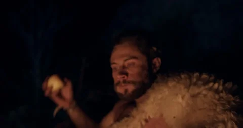 Scared man eating apple at night Stock Footage 130011357