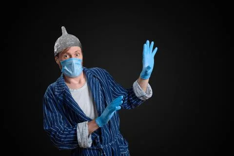 Scared man in foil cap, holey bathrobe, gloves and medical mask Stock Photos