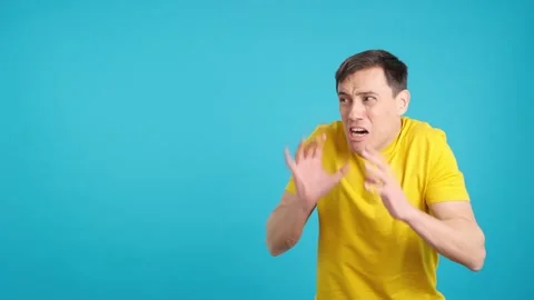 Scared man gesturing with hands in fear and looking away Stock Footage 243565293
