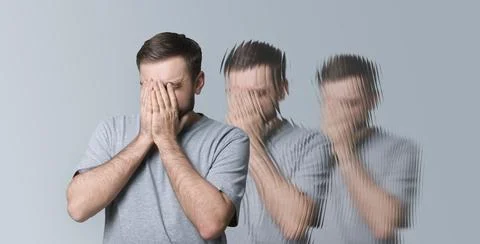 Scared man having hallucination on light grey background. Distorted image Stock Photos