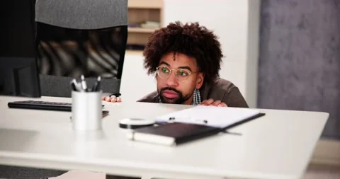 Scared Man Hiding Behind Office Desk Stock Footage 226125282