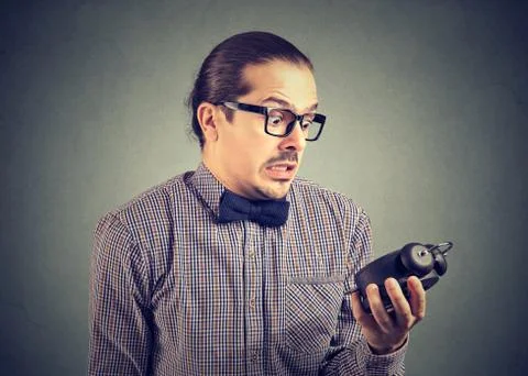 Scared man looking at alarm clock Stock Photos