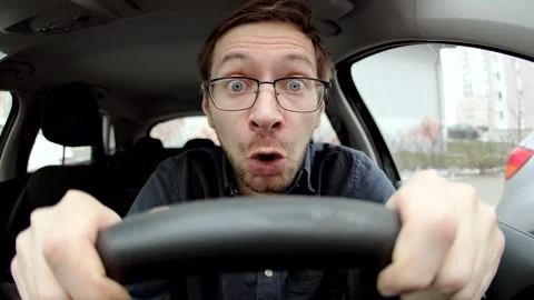 Scared novice man in glasses driving a car. Stock Footage 301247137