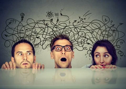 Scared people exchanging share different thought peeking from under the table Foto stock