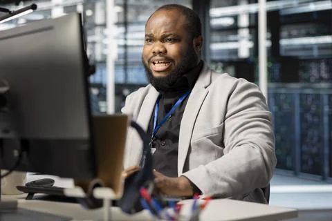 Scared programmer in server room panicked by critical hardware malfunction Stock Photos