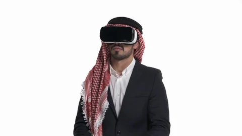 Scared, shocked Arab man using VR headset and exploring another world, isolated Stock Footage 125830179