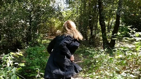 Scared terrified Woman Running Away From somebody Into Forest- slow motion Stock Footage