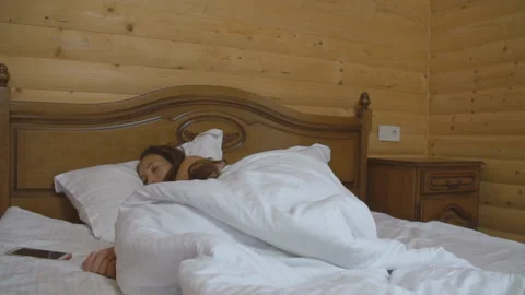 Scared woman lying in bed Stock Footage 129589857