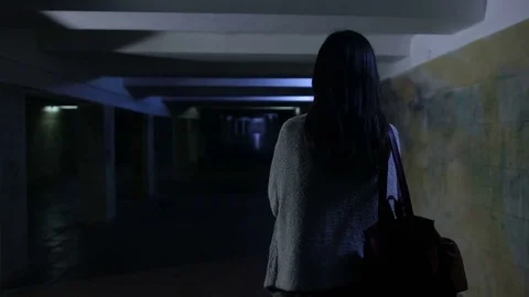Scared woman screaming in dark underpass at night Stock Footage