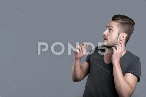Scared young man raising hands Stock Photos