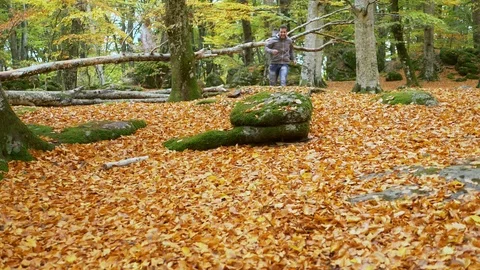 Scared young man running away running and jumping in the forest Stock Footage 92768910