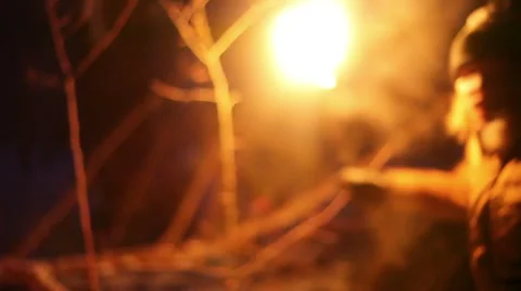 Scared young man running with the torch at night in the winter forest Stock Footage 64701827