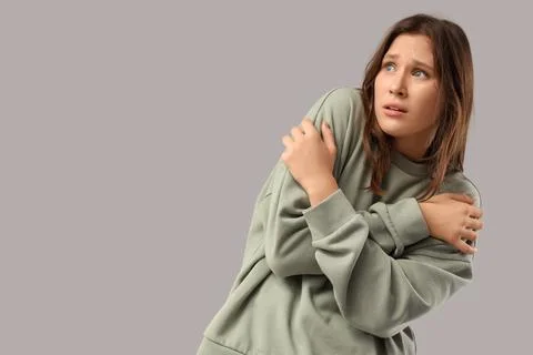 Scared young woman on light background Stock Photos