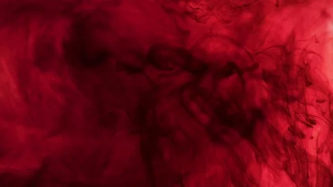 Scarlet paint dissolves in the liquid. Slow motion Stock Footage 82322995