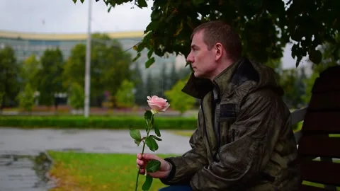 A scarlet rose in the hand of a guy on a date Stock Footage 160855056