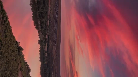 Scarlet sunset with fluffy clouds over a calm mirror river and chalk hills. Stock Footage 249381067
