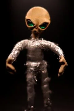 Scary alien from clay on dark background Stock Photos