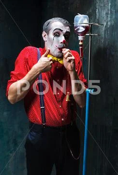 The scary clown and drip with blood on dack background. Halloween concept Stock Photos